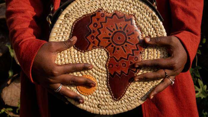 Mãos seguram peça de couro com mapa da África
